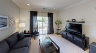 This thoughtfully designed two-bedroom, two-bathroom residence at The New Yorker in Hamilton, NJ, offers a single-level floor plan that balances comfort and functionality. Crown molding and recessed lighting are consistent throughout, lending a polished character to the home.

The living room features plush carpeting, a sliding glass door that opens to a private balcony, and an abundance of natural light. It flows naturally into the dedicated dining area, which is anchored by an elegant chandelier and provides a seamless connection to the kitchen.

The kitchen is well-equipped with rich cherry wood cabinetry, granite countertops, a mosaic tile backsplash, and stainless steel appliances including a gas range and French door refrigerator.

Both bedrooms are carpeted and filled with natural light from generously sized windows. The primary bedroom includes an en-suite bathroom featuring tile flooring, a soaking tub, a separate glass-enclosed shower, and a granite-topped vanity. The second bathroom offers a clean, functional design with a wood-toned vanity and tile flooring.

Overall, the residence presents a cohesive, neutral palette with quality finishes throughout.