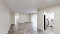 Located at 1748 Jennifer Rd in Lexington, Kentucky, this two-bedroom, one-bathroom single-floor home offers a clean, modern aesthetic throughout. The open living and dining areas are finished with light-toned luxury vinyl plank flooring and neutral gray walls, creating a bright and cohesive feel. A sliding glass door with vertical blinds in the living room adds natural light and visual openness.

The kitchen has been thoughtfully updated with white shaker-style cabinetry accented by matte black hardware, marble-look countertops, a subway tile backsplash, a stainless steel sink with a modern pull-down faucet, and stainless steel appliances including a range and refrigerator.

Both bedrooms are carpeted and feature ceiling fans with integrated lighting, neutral gray walls, and natural light from windows with blinds. The primary bedroom is generously sized and includes dedicated closet access, while the second bedroom also offers a closet. The home provides an impressive six closets in total, ensuring ample storage throughout.

The bathroom is fitted with a tub-shower combination featuring a rainfall-style showerhead with matte black fixtures and a window that brings in natural light. The single-floor layout is connected by a central hallway, making for an efficient and easy-to-navigate floor plan.