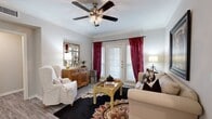 This thoughtfully designed one-bedroom, one-bathroom single-story residence offers an efficient and comfortable layout across a well-utilized floor plan. Entry is made through a hallway featuring a paneled front door, providing a welcoming transition into the main living areas.

The living room is a bright, inviting space highlighted by crown molding, hardwood-style flooring, a ceiling fan with light fixture, and a set of French doors that open to a private patio, allowing natural light to pour in. The kitchen is well-equipped with crisp white cabinetry, granite-style countertops, a deep double-basin stainless steel sink, and stainless steel appliances including a refrigerator, range, microwave, and dishwasher. Light tile flooring and a skylight enhance the kitchen's airy feel. The kitchen flows seamlessly into a dedicated dining area, creating an open and functional common space.

The bedroom is a comfortable retreat featuring a ceiling fan, large windows with natural light, hardwood-style flooring, and access to a closet. The bathroom includes a granite-topped vanity, a tub-shower combination, tile flooring, and a conveniently integrated stacked washer and dryer unit, adding practical in-unit laundry access. Crown molding details carry throughout the space, contributing to a cohesive and polished aesthetic.