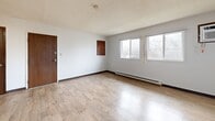 Located at 340 29th Street Dr SE in Cedar Rapids, Iowa, this 2-bedroom, 1-bathroom single-floor unit offers a practical and functional layout. The living room is a standout space, featuring light wood-look flooring, a charming stone-surround fireplace, and dual windows that invite natural light and outdoor views. Baseboard heating runs throughout the unit, and a wall-mounted A/C unit in the living area provides additional climate control.

The kitchen flows openly from the living area and is equipped with dark wood cabinetry, white appliances including a refrigerator, dishwasher, electric range with overhead ventilation, and a sink with ample counter space. A ceiling fan and easy access to the entry door make the kitchen-dining area both convenient and well-ventilated.

Both bedrooms feature plush carpeting, ceiling fans, and windows with neighborhood views. The primary bedroom includes a built-in closet with sliding wood-panel doors, while additional closets throughout the unit provide generous storage. The shared bathroom is clean and straightforward, offering a tiled tub-shower combo, a toilet, and a vanity with a white countertop set over wood-look tile flooring. With four closets total and a well-connected hallway, this unit provides organized, efficient living.