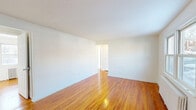 Located at 90 Marilyn Place in Clifton, NJ, this one-bedroom, one-bathroom unit offers a well-organized single-floor layout that makes efficient use of its space. Warm-toned hardwood floors flow throughout the living areas and bedroom, lending a cohesive and inviting character to the home. The living room is bright and open, with clean white walls that reflect natural light and create an airy feel. A separate dining room provides a dedicated space for meals, adding structure to the layout. The kitchen features white cabinetry, granite-style countertops, a gas range, and a double-basin sink, with a window that draws in natural light and views of the outdoors. Radiant heat radiators are present throughout, offering classic and efficient heating. The bedroom is comfortably sized, bathed in natural light from a double-pane window with an exterior view, and includes its own radiator. Three closets throughout the unit provide ample storage. The bathroom is cleanly finished with tile flooring, a full bathtub with shower, a vanity with cabinet storage, and a window for ventilation. A hallway connects the rooms efficiently, and the entry door features decorative glass panels.