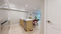 Located at 2673 Trinity St in Abbotsford, BC, this well-appointed 2-bedroom, 2-bathroom residence offers a thoughtfully designed single-level layout with modern finishes throughout. The open-concept kitchen and living area forms the heart of the home, featuring a sleek kitchen with white upper cabinetry, warm wood-toned lower cabinets, white quartz countertops, stainless steel appliances, and light hardwood flooring that extends seamlessly into the dining and living spaces. The living room is bright and welcoming, with large windows and a glass door that invite natural light and provide views of the outdoor surroundings. Both bedrooms are comfortably sized, each featuring large windows that overlook the exterior greenery, light hardwood floors, and a calm, neutral colour palette. The primary bedroom includes a sliding-door closet for convenient storage. The two bathrooms are finished with elegant grey marble-style tile flooring and light wood vanities topped with white quartz surfaces. One bathroom features a walk-in glass-enclosed shower, while the other is equipped with a round black-framed mirror, adding a contemporary accent. A dedicated closet and hallway complete the efficient, well-organized layout of this modern Abbotsford residence.
