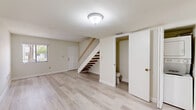 Located at 8340 NW 7th St in Miami, FL, this two-story, two-bedroom, two-bathroom home offers a practical and well-organized layout spread across two floors of nearly equal size. Light wood-tone flooring flows consistently throughout the home, lending a clean, cohesive look to every room.

The ground floor features a welcoming living and dining area with a staircase accented by a white banister and warm wood treads. A conveniently located bathroom sits just off the main living space. The kitchen is efficiently designed with wood-grain cabinetry, granite-style countertops, and white appliances including a range, dishwasher, and refrigerator. A large sliding glass door floods the kitchen with natural light and provides access to outdoor views, while vertical blinds offer privacy.

Upstairs, the two bedrooms are bright and airy, each featuring windows with vertical blinds that bring in natural light. The primary bedroom offers a comfortable footprint with generous closet space, complemented by additional closets throughout the home — five in total. The full bathroom on this floor includes a tiled tub-shower combination, a vanity with wood-grain cabinetry, and clean, neutral finishes. A balcony, hallway, laundry area, and additional storage complete this well-appointed Miami home.