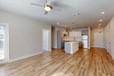 Located at 4854 Greenhouse Rd in Houston, TX, this well-designed 2-bedroom, 2-bathroom single-floor home offers a bright and modern living experience. The open-concept layout seamlessly connects the living room, dining area, and kitchen, all finished with light wood-look flooring that enhances the airy, welcoming ambiance. Ceiling fans in the main living and bedroom areas add comfort throughout.

The kitchen is a standout feature, equipped with white shaker-style cabinetry, stainless steel appliances including a gas range, microwave, and refrigerator, quartz countertops, and a central island with pendant lighting — ideal for both cooking and casual dining.

The bedrooms are carpeted and filled with natural light from large windows. The primary bedroom includes a spacious walk-in closet with built-in shelving. Two full bathrooms feature wood-look flooring, subway tile tub surrounds, and clean, modern finishes. Three closets throughout provide ample storage.

Additional functional spaces include a dedicated laundry room, utility room, and entrance hallway. A private outdoor area with a wood privacy fence and metal railing offers a peaceful retreat. The neutral color palette and contemporary design make this a polished, move-in-ready home.
