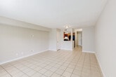 Located at 3901 Michael Blvd in Mobile, Alabama, this two-floor residence offers a practical and comfortable layout throughout its various living spaces. The main living area is open and airy, finished with light-toned ceramic tile flooring that extends into the kitchen, creating a cohesive and easy-to-maintain flow. Neutral gray walls and white trim run throughout, giving the space a clean, understated aesthetic.

The kitchen is efficiently designed in a galley-style configuration, featuring warm wood cabinetry, granite-patterned countertops, a double stainless steel sink, and black appliances including a gas range and refrigerator. A dishwasher is also integrated beneath the counters, rounding out the kitchen's functionality.

The bedrooms are carpeted and each equipped with a ceiling fan and light fixture, providing comfort and air circulation. Windows with horizontal blinds allow for natural light while maintaining privacy.

The bathrooms are finished with tile flooring, wood vanities topped with granite-style countertops, and shower/tub combos with curtain rods. The clean, white fixtures throughout give each bathroom a tidy, functional appearance.

Overall, the space presents a straightforward and well-maintained interior, well-suited for everyday living with consistent finishes across both floors.