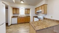 Located at 901 N 35th St in Council Bluffs, Iowa, this two-story home offers a practical and well-organized layout across two floors. The main level features a combined dining and living area with wood-look plank flooring, vertical blinds, and windows that allow natural light to fill the space. The kitchen is equipped with warm oak cabinetry, granite-style countertops, a gas range, dishwasher, and a peninsula that provides additional prep space — all complemented by durable hardwood-style flooring. A hallway connects the main living areas to the staircase leading to the upper level. Upstairs, three bedrooms are finished with plush carpeting and feature windows with outdoor views of the surrounding neighborhood. Each bedroom includes dedicated closet space with oak-finished doors. The home's single full bathroom features a tub-shower combination with chrome fixtures. Throughout the home, textured ceilings, warm wood trim, and neutral wall tones contribute to a clean, move-in ready aesthetic. With four closets distributed across the home, storage is well-accounted for. The layout is efficient and functional, making this a solid two-story home suitable for a variety of living arrangements.
