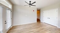 Located at 845 Greenfield Rd in Lancaster, PA, this thoughtfully designed single-story home offers three bedrooms and one bathroom across a well-proportioned floor plan. The open-concept kitchen and living area serve as the heart of the home, featuring sleek white cabinetry that extends to the ceiling, a classic white subway tile backsplash, light quartz countertops, stainless steel appliances, and a large kitchen island with a matte black faucet and pendant lighting above. Light wood-look flooring runs throughout the main living areas, lending warmth and continuity to the space. The living room is bright and airy, highlighted by French doors with transom windows above that invite natural light and provide outdoor views, complemented by a modern ceiling fan. Each bedroom is carpeted for comfort and features ceiling fans, neutral walls, and windows with blinds that frame outdoor views. The bedrooms are served by closets with wire shelving, providing practical storage. The primary bedroom is a generous size, with its own dedicated closet space. A dedicated entrance and additional closet round out the layout. The home's clean, modern aesthetic, characterized by crisp white trim, neutral tones, and contemporary fixtures, creates a cohesive and inviting atmosphere throughout.