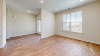 Located at 7121 Elroy St in Austin, TX, this well-designed single-story unit offers a functional and modern layout across a compact yet comfortable floor plan. The open-concept kitchen and living area serves as the heart of the home, featuring warm hardwood-style flooring, recessed lighting, and large windows fitted with blinds that invite abundant natural light. The kitchen is outfitted with crisp white shaker-style cabinetry, granite countertops, a stainless steel sink, and a full suite of stainless steel appliances including a refrigerator, electric range, microwave, and dishwasher — delivering both style and practicality. The bedroom is a comfortable retreat finished with plush neutral carpet, a ceiling fan, and a bright window with outdoor views. It includes access to a dedicated walk-in closet with built-in shelving, providing generous storage. Throughout the unit, a neutral warm-toned color palette on the walls complements the flooring and finishes, creating a cohesive and inviting ambiance. The overall design is clean and contemporary, making this Austin unit an efficient and appealing space suited for everyday living.
