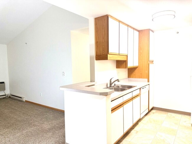 Kitchen with peninsula counter. - Waitlist - Cross Plains Apartments Near Madison | In-Unit Laundry | Walk-In Closets | Trail Access