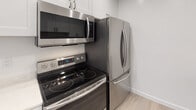 Located at 22416 Ocean Ave in Torrance, California, this single-floor residence offers a thoughtfully designed layout with clean, modern finishes throughout. The kitchen is outfitted with a full suite of stainless steel Samsung appliances, including a French door refrigerator, electric range with ceramic cooktop, and an over-the-range microwave. White cabinetry with sleek hardware completes the space, complemented by light wood-style flooring that adds warmth and continuity.

The bathroom features a crisp, all-white aesthetic with a quartz-topped vanity, undermount sink, chrome fixtures, a large wall mirror, and a tiled tub and shower combination. Light wood flooring carries through here as well, creating a cohesive, refreshed look.

The bedroom offers plush carpeting, soft neutral wall tones, and a mirrored sliding closet that enhances the sense of space. An adjacent doorway provides convenient access to the bathroom beyond.

The living area is generously proportioned with the same comfortable carpeting and neutral palette. A sliding glass door opens directly onto a private balcony, allowing natural light to fill the room and offering a pleasant outdoor retreat. This residence combines practical modern updates with a comfortable, move-in ready atmosphere in a desirable Torrance location.