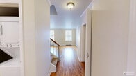 Located at 1518 Park Ave in Baltimore's Park Avenue corridor, this two-story, 2-bedroom, 2-bathroom home offers a thoughtfully arranged layout spread across two floors. The main level features a welcoming entrance that opens into a bright living room showcasing warm hardwood floors, elegant crown molding, a classic brick fireplace, and dual windows that draw in generous natural light. A staircase with a wood handrail and metal balusters connects the floors, accompanied by a hallway and closet for added convenience. The kitchen is also situated on this level. Upstairs, the second floor hosts both bedrooms, each carpeted and finished in neutral tones. The primary bedroom is a comfortable retreat with a narrow window and baseboard heating. The second bedroom features a skylight, adding a bright, airy quality to the space. Both bathrooms are clean and functional, with one featuring a full tub-shower combination with white tile surround and tile flooring. With four closets distributed throughout, storage is plentiful. Baseboard heating is present throughout both floors. The home's layout balances practicality with classic charm, making it a well-rounded residence in the heart of Baltimore.