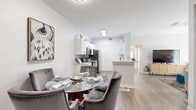 Located in Tampa, FL, this single-story, 3-bedroom, 3-bathroom residence offers a well-designed open-concept layout filled with natural light. The combined kitchen and living area serves as the heart of the home, where a modern kitchen showcases white shaker cabinetry, quartz countertops, a subway tile backsplash, stainless steel appliances, and wood-style flooring. A breakfast bar connects seamlessly to the dining area, creating an ideal flow for everyday living and entertaining. The living room is bright and airy, featuring a ceiling fan and large sliding glass doors that open to a private outdoor patio with views of lush greenery. The primary bedroom is generously sized with a bay window configuration that floods the carpeted space with natural light, complemented by a ceiling fan and access to a walk-in closet with built-in wire shelving. Two additional bedrooms provide comfortable, well-lit accommodations. All three bathrooms are finished with clean white vanities, quartz countertops, and tub-shower combinations with wood-look tile flooring. The unit also includes a dedicated laundry area, two closets for added storage, and hallways that connect the layout efficiently. The overall aesthetic is modern and neutral throughout.