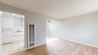 Located at 3814 Baldwin Ave in El Monte, CA, this single-floor 1-bedroom, 1-bathroom unit offers a well-organized layout that maximizes every square foot of living space. Light-toned hardwood-style flooring runs throughout the main living areas, complemented by neutral gray walls and textured ceilings that lend a clean, cohesive look. The open living and dining area is bright and airy, featuring a ceiling fan and a wall-mounted heater unit. Large windows with vertical blinds allow natural light to fill the space, creating a welcoming ambiance. The galley-style kitchen is outfitted with white cabinetry on both sides, tile countertops with a double-basin sink, white subway tile backsplash, a gas range, and light ceramic tile flooring. A ceiling fan adds comfort to this functional cooking space. The bedroom is a comfortable size, featuring hardwood-style flooring, a window with vertical blinds, and a reach-in closet, with an additional closet available in the hallway. The full bathroom includes a vanity with under-sink storage, a mirrored medicine cabinet, and a glass-door shower enclosure over tiled walls, all finished with tile flooring. A hallway connects the main living spaces to the bedroom and bathroom, enhancing the overall flow of the home.