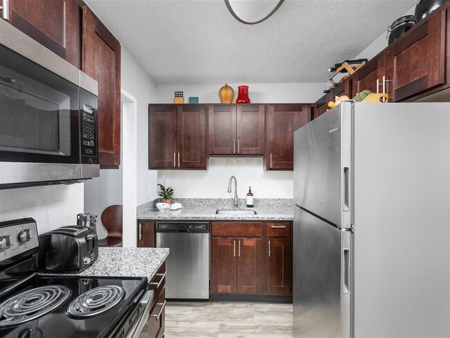 Updated kitchen with stainless steel appliances - Three Rivers Apartments