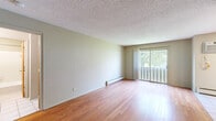 Located at 2701 Brunswick Ave N in Crystal, MN, this one-bedroom, one-bathroom unit offers efficient single-floor living with a thoughtful layout. The living room is a bright, open space featuring warm hardwood flooring, a textured ceiling, and a sliding glass door that opens to a private balcony with outdoor views of mature trees — allowing natural light to fill the room throughout the day. A baseboard heating system runs along the exterior wall for year-round comfort.

The galley-style kitchen is well-appointed with warm oak cabinetry, granite-look countertops, white tile flooring, and stainless steel appliances including a refrigerator, range, and over-the-range microwave. Track lighting overhead ensures the space is well-lit and functional.

The spacious bedroom offers plush carpeting, a large bifold closet, and a window with outdoor views, providing a comfortable and private retreat. Direct access to the bathroom is conveniently located just off the bedroom.

The bathroom features a clean, classic design with tile flooring, a vanity with ample cabinet storage, and a full tub-shower combination. Neutral tones throughout the unit create a cohesive, move-in-ready aesthetic ideal for comfortable everyday living.