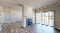Located at 4600 Bellaire Drive South in Fort Worth, TX, this two-story, three-bedroom, two-bathroom home offers a well-organized layout across two levels. The main living level hosts an open-concept dining room, kitchen, and living room that flow seamlessly together. The living room features wood-look flooring, crown molding, and a tile-surround fireplace with a white mantel, flanked by a sliding glass door with vertical blinds that floods the space with natural light. The kitchen is equipped with rich wood cabinetry, granite countertops, a subway tile backsplash, stainless steel appliances, and a central island with pendant lighting — ideal for both everyday cooking and entertaining. The bathrooms are appointed with warm wood vanities, granite countertops, and large mirrors. The three bedrooms feature plush carpeting, ceiling fans, crown molding, and generous windows. One bedroom includes built-in shelving, while the primary bedroom connects to its own bathroom and closet. Additional spaces include a pantry, laundry room, hallway, and three closets providing ample storage. Carpeted staircases connect the levels, and the attached garage with an automatic opener completes this functional and comfortable home.