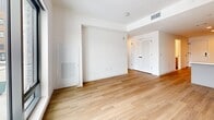 Located at 801 Orange Street in Wilmington, Delaware, this modern 3-bedroom, 2-bathroom unit offers a thoughtfully designed single-floor layout that maximizes every square foot. Light wood-tone flooring flows consistently throughout the living areas and bedrooms, creating a warm, cohesive aesthetic against crisp white walls.

The kitchen is outfitted with stainless steel appliances, including a refrigerator, electric range, built-in microwave, and dishwasher. Gray-toned cabinetry with matte black hardware pairs with white countertops, offering both style and functionality. The kitchen opens conveniently toward the living area, which is bright and open with ample room to arrange furnishings.

The primary bedroom features a closet and direct access to one of the two bathrooms. That bathroom is finished with large-format tile flooring, a wood-framed vanity with a white countertop, a sleek rounded mirror with accent lighting, and a glass-enclosed marble-tiled shower. The second bathroom offers a similar vanity and mirror design, complemented by dark tile flooring and grab-bar accessibility features.

The additional bedrooms are well-proportioned, with built-in closets and large floor-to-ceiling windows that invite abundant natural light and offer open views of the surrounding Wilmington streetscape. The unit presents a clean, contemporary finish throughout.