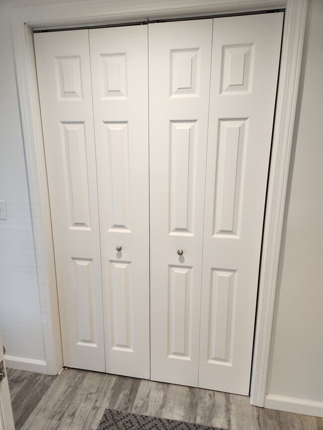 Coat closet in living room - 23 Brush Hill Rd