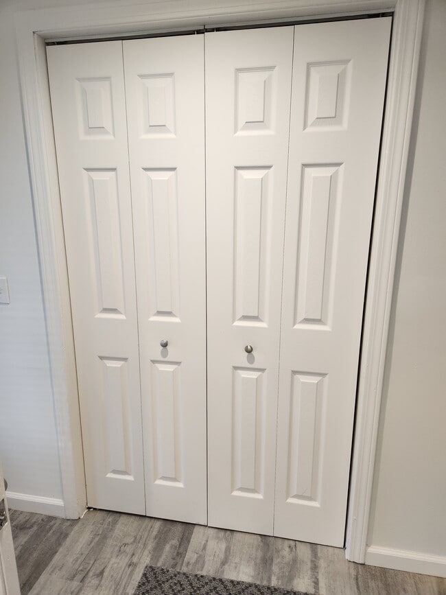 Coat closet in living room - 23 Brush Hill Rd