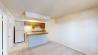 Located at 3016 SW 89th St in Oklahoma City, Oklahoma, this one-bedroom, one-bathroom unit is thoughtfully designed to maximize its compact footprint across a single floor. The layout includes a kitchen, bedroom, bathroom, and closet, offering a complete and self-contained living arrangement.

The kitchen serves as a functional centerpiece of the unit, featuring warm-toned oak cabinetry with ample upper and lower storage, a full suite of white appliances including a refrigerator, electric range, and dishwasher, and a double-basin sink. A peninsula with a butcher block countertop extends the workspace and provides additional seating potential. Light marble-style tile flooring ties the kitchen together with a clean, bright aesthetic.

The bedroom offers a comfortable retreat with plush wall-to-wall carpeting, neutral wall tones, and a ceiling fan with light fixture for year-round comfort. A window allows natural light to fill the room, and an adjacent closet provides dedicated storage. The bedroom connects conveniently to the bathroom.

The bathroom is finished with the same light tile flooring as the kitchen, complemented by a vanity with oak cabinetry, a white countertop, and a well-lit mirror above. Textured walls and a towel bar complete the practical and tidy design. Overall, the unit presents a straightforward, functional layout suitable for efficient everyday living.