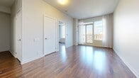 Located at 188 Clark Blvd in Brampton, Ontario, this well-designed one-bedroom, one-bathroom unit offers a functional and modern living experience across a single floor. Rich hardwood flooring runs throughout, creating a warm and cohesive aesthetic in every room.

The open-concept living area is bright and airy, anchored by floor-to-ceiling windows dressed with sheer curtains that invite generous natural light and offer elevated city views of the surrounding Brampton skyline. The space flows seamlessly into the kitchen, which features warm wood cabinetry extending to the ceiling for ample storage, grey tile backsplash, stainless steel appliances including a refrigerator, microwave, and range, and a peninsula with a white countertop and integrated sink — ideal for both cooking and casual dining.

The bedroom is a comfortable, well-proportioned retreat finished with the same hardwood flooring and neutral walls, with access to a walk-in closet area. The bathroom is clean and contemporary, showcasing large-format floor tiles, a wood-accented vanity with a white countertop, an oversized mirror, and a glass-enclosed walk-in shower with grey subway tile surround. Every detail of this unit reflects a modern, functional design sensibility suited for comfortable urban living.