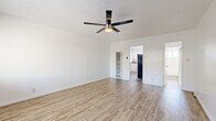 Located at 345 S Westlake Ave in the heart of Los Angeles, this single-floor unit offers a well-organized and efficiently designed layout. Light wood-tone flooring runs consistently throughout the space, lending warmth and visual continuity to every room.

The living room is open and bright, featuring crisp white walls, a ceiling fan with integrated lighting, and large windows that invite natural light and views of the surrounding area. The space feels airy and versatile, accommodating a variety of furniture arrangements.

The kitchen is thoughtfully appointed with white shaker-style cabinetry, gray laminate countertops, and a stainless steel sink positioned beneath a window with horizontal blinds. A gas range with stainless steel appliances, including an over-the-range microwave, completes the cooking area, making it both practical and visually clean.

The bathroom continues the light, neutral aesthetic with all-white wall tiling, a shower-tub combo with a brushed nickel fixtures, a window for natural ventilation, and a built-in storage cabinet. Wood-look tile flooring ties the bathroom back to the rest of the unit.

A dedicated closet provides additional storage. The unit's consistent use of neutral tones and modern finishes throughout creates a cohesive, clean, and functional living environment.