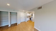 Located at 300 W Airport Blvd in Sanford, Florida, this single-floor, 2-bedroom, 2-bathroom residence offers a functional and well-appointed layout designed for comfortable living. The living room serves as the heart of the home, featuring wood-look flooring, neutral gray walls, a textured ceiling, and a set of French doors that invite natural light and provide outdoor views. The kitchen is efficiently designed with white shaker-style cabinetry, granite-look countertops, and stainless steel appliances including a refrigerator, microwave, and range. It connects seamlessly to a hallway that leads to both bedrooms and bathrooms. The primary bedroom offers a generous footprint with wood-look flooring, a window for natural light, and access to a dedicated closet fitted with wire shelving on both sides for ample storage. The second bedroom mirrors the clean, neutral aesthetic with its own window and hardwood-style flooring. Both bathrooms are fitted with a tub-shower combo and clean white fixtures. Throughout the residence, consistent flooring, crisp white trim, and a soft gray color palette create a cohesive and move-in-ready atmosphere.