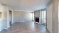 Located at 6675 Old Canton Rd in Ridgeland, Mississippi, this one-bedroom, one-bathroom residence offers a well-organized and functional single-floor layout. The open living room serves as the heart of the home, showcasing durable wood-style plank flooring, neutral gray walls, and a textured ceiling. A classic fireplace with a white mantel is flanked by two large windows fitted with blinds, flooding the space with natural light and creating a bright, welcoming ambiance. The entry door opens directly into this living area, providing a seamless flow throughout the unit. Adjacent to the living room, the galley-style kitchen is efficiently designed with gray cabinetry, white countertops, a double-basin sink, and stainless steel appliances including a refrigerator and dishwasher. Light wood-tone flooring ties the kitchen together with a clean, practical finish. The bedroom is a comfortable retreat featuring soft carpeting, a ceiling fan with light fixture, and a window that brings in natural light. It offers direct access to both a dedicated closet and the full bathroom. The bathroom is appointed with a single-sink vanity with white countertop, a large mirror, globe light bar, and a textured wall finish, completing this efficiently designed residence.