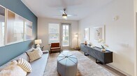 Located at 601 McCaw Bridge St, Unit 103 in Raleigh, NC, this well-appointed one-bedroom, one-bathroom residence offers a thoughtfully designed single-level layout. The open-concept living and kitchen area forms the heart of the unit, where warm hardwood-style flooring, recessed lighting, and a neutral color palette create a bright, welcoming atmosphere. The kitchen is outfitted with white shaker cabinetry, granite countertops, subway tile backsplash, and a full suite of stainless steel appliances, including a refrigerator, range, microwave, and dishwasher. A kitchen island provides additional prep space and casual dining. The living room features a distinctive blue accent wall, a ceiling fan, and windows that invite natural light and outdoor views. The bedroom is a comfortable retreat with plush carpeting, a ceiling fan, natural light from a dedicated window, and ample space for furnishings. The full bathroom includes a granite-topped vanity, hardwood-style flooring, and a tiled tub-shower combination. A dedicated laundry room houses a full-size washer and dryer. A hallway and closet round out the functional layout, making efficient use of the available space throughout this clean, modern Raleigh residence.