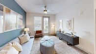 Located at 601 McCaw Bridge St, Unit 103 in Raleigh, NC, this well-appointed one-bedroom, one-bathroom residence offers a thoughtfully designed single-level layout. The open-concept living and kitchen area forms the heart of the unit, where warm hardwood-style flooring, recessed lighting, and a neutral color palette create a bright, welcoming atmosphere. The kitchen is outfitted with white shaker cabinetry, granite countertops, subway tile backsplash, and a full suite of stainless steel appliances, including a refrigerator, range, microwave, and dishwasher. A kitchen island provides additional prep space and casual dining. The living room features a distinctive blue accent wall, a ceiling fan, and windows that invite natural light and outdoor views. The bedroom is a comfortable retreat with plush carpeting, a ceiling fan, natural light from a dedicated window, and ample space for furnishings. The full bathroom includes a granite-topped vanity, hardwood-style flooring, and a tiled tub-shower combination. A dedicated laundry room houses a full-size washer and dryer. A hallway and closet round out the functional layout, making efficient use of the available space throughout this clean, modern Raleigh residence.