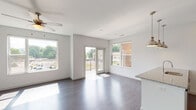 Located on Ward Street in Cincinnati's 45227 zip code, this single-floor residence showcases a thoughtfully designed open-concept layout with modern finishes throughout. The living area is bright and welcoming, featuring dark hardwood-style flooring, a ceiling fan, and multiple large windows that flood the space with natural light and offer views of the surrounding neighborhood. Glass doors lead directly to a private balcony, extending the living space outdoors.

The kitchen is a standout feature, equipped with rich dark-wood cabinetry, granite countertops, a subway tile backsplash, and a full suite of stainless steel appliances including a range, microwave, and refrigerator. A peninsula with pendant lighting creates a natural divide between the kitchen and living area, ideal for casual dining or entertaining.

The bedrooms are carpeted for comfort, each featuring windows that bring in generous natural light. The primary bathroom includes a walk-in glass shower, a granite-topped vanity with dark cabinetry, and hardwood-style flooring. A secondary bathroom offers a full tub-shower combination with matching granite and cabinetry finishes, maintaining a consistent aesthetic throughout. The overall design is clean, contemporary, and move-in ready.