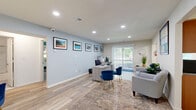 Located at 82 Beverly Hill Terr in Woodbridge, NJ, this well-appointed one-bedroom, one-bathroom residence offers a thoughtfully designed single-floor layout with generous living space. Light wood-style flooring runs throughout the main areas, complemented by soft blue-gray walls and recessed lighting that create a bright, welcoming atmosphere.

The open living room is a standout feature, offering ample room for both lounging and a dedicated workspace, with a sliding glass door that leads to a private balcony and fills the space with natural light. Framed artwork adorns the walls, adding a polished touch. A wide hallway connects the main living areas with ease.

The kitchen is well-equipped with warm wood cabinetry, granite countertops, a marble-style tile backsplash, and stainless steel appliances including a dishwasher and refrigerator. A skylight enhances the natural brightness of this functional space.

The spacious primary bedroom features plush carpeting, a bold green accent wall, and a large window allowing natural light to filter in. Four closets throughout the unit provide exceptional storage. The bathroom is elegantly finished with marble-style tiled walls, a tub-shower combo with sliding glass doors, and a granite vanity countertop.