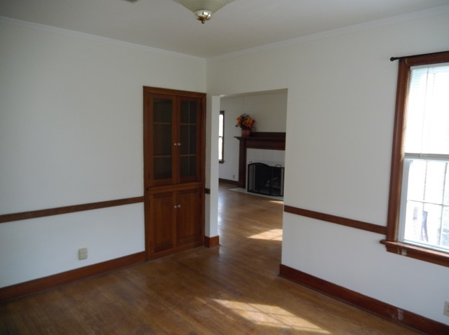 Dining room has a built-in cabinet and open to living room, which has a fireplace. - 742 E Ford Ave