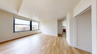 Located at 333 N Pennsylvania St in the heart of downtown Indianapolis, this one-bedroom, two-bathroom unit offers a well-designed, efficient layout finished with consistent light wood flooring throughout. The open living area is bright and airy, anchored by large windows that frame elevated views of the Indianapolis cityscape, including landmarks and surrounding urban architecture. The kitchen features warm wood cabinetry, granite-style countertops, a stainless steel sink, and a dishwasher, positioned conveniently near the entry door. The bedroom is a comfortable, well-proportioned retreat equipped with a ceiling fan and its own set of large windows providing additional city views and natural light. A dedicated walk-in closet off the bedroom offers wire shelving for organized storage. Both bathrooms are finished with wood-toned vanities and granite countertops; one bathroom includes a glass-enclosed shower stall. Throughout the unit, crisp white walls and clean trim create a neutral, move-in-ready aesthetic. The overall ambiance is modern and functional, well-suited for urban living in one of Indianapolis's most central and walkable neighborhoods.