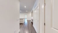 Located at 95 Maple St in Stoneham, MA, this thoughtfully designed 3-bedroom, 2-bathroom residence offers a well-organized single-level floor plan with generous living space throughout. The open-concept kitchen and living area serves as the heart of the home, featuring a large center island with dark granite countertops, sleek flat-panel white cabinetry, a marble-style backsplash, stainless steel appliances, and recessed lighting. The living area extends to a private balcony through sliding glass doors, filling the space with natural light and outdoor views. Durable hardwood-style flooring flows consistently throughout the main living areas and all three bedrooms. Each bedroom is bright and airy, with large windows offering views of the surrounding neighborhood. The primary bedroom is a comfortable size and benefits from abundant closet space — the residence includes six closets in total, with well-organized wire shelving systems. Both bathrooms are elegantly finished with large-format marble-style tile flooring, soaking tubs with marble-tiled surrounds, dark granite vanity tops, and modern fixtures. Additional functional spaces include a dedicated laundry room and utility room, rounding out this clean, contemporary residence.