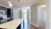 This contemporary 600 square foot apartment in San Francisco offers a blend of modern design and urban living. The open-concept floor plan maximizes space, featuring a combined kitchen and living area. The kitchen boasts dark wood cabinetry, stainless steel appliances, and a central island, perfect for both cooking and entertaining. Floor-to-ceiling windows flood the space with natural light and provide stunning city views, creating an airy atmosphere throughout.

The bedroom, measuring 140 square feet, continues the modern aesthetic with plush carpeting and large windows. The bathroom is sleek and functional, with a tiled shower-tub combination and built-in shelving for added storage. Hardwood floors in the main living area add warmth and elegance to the space.

A standout feature is the apartment's industrial-chic elements, including exposed concrete pillars that add character to the neutral color palette. The property's single floor layout ensures easy accessibility, while the closet provides ample storage space. Located at 185 Channel St in San Francisco, this apartment offers a perfect balance of style and functionality for urban dwellers seeking a contemporary living space.