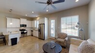 This single-story, 2-bedroom, 2-bathroom residence offers a thoughtfully designed open-concept layout that efficiently connects the main living areas. Polished concrete floors flow continuously throughout the home, providing a cohesive and low-maintenance foundation that complements the neutral, light-toned walls.

The kitchen is outfitted with white shaker-style cabinetry, granite countertops, and a full suite of stainless steel appliances, including a French door refrigerator, gas range, dishwasher, and microwave. A peninsula with additional counter space connects the kitchen to the dining area, which is anchored by an elegant chandelier and receives natural light from nearby windows.

The living room is comfortable and well-lit, featuring recessed lighting, a ceiling fan, and windows that invite natural light. Both bedrooms maintain the polished concrete flooring, soft wall tones, and ceiling fans, creating a calm, restful atmosphere.

The bathrooms are clean and functional, with the full bath offering a tub-shower combination and white cabinetry for storage. A dedicated laundry area with overhead cabinetry and washer/dryer connections adds practical convenience. Overall, the home presents a clean, modern aesthetic throughout.