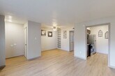 Located in Huntsville, Texas, this single-story residence offers a well-organized layout with one bedroom, two bathrooms, and a thoughtfully arranged living space. Light wood-style flooring flows throughout the main living and dining area, creating a bright and clean aesthetic complemented by neutral wall tones and crisp white trim. The open living and dining room is anchored by a ceiling fan with light fixture and features a built-in shelving unit, adding both function and character to the space. An adjacent kitchen is efficiently designed with rich dark wood cabinetry, granite-style countertops, a stainless steel refrigerator, and a range, all accented by subtle tile backsplash details. The bedroom is carpeted and features a ceiling fan, a window with blinds that allows natural light, and ample closet space — three closets are distributed throughout the unit for generous storage. The two bathrooms are finished with light countertops and wood-toned vanity cabinetry, maintaining a consistent and cohesive design palette. A hallway connects the various rooms, contributing to the efficient and functional flow of the floor plan. The overall ambiance is clean, practical, and move-in ready, making it a comfortable option in the Huntsville area.