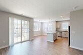 Located at 100 Flint Pond Cir, Unit 7131 in Shrewsbury, MA, this well-appointed 2-bedroom, 2-bathroom residence offers a thoughtfully designed single-floor layout. The open-concept living and dining area is bathed in natural light through multiple windows and sliding glass doors that lead to an outdoor balcony, creating a bright and airy atmosphere. Light-toned hardwood-style flooring flows throughout the main living areas, complementing the neutral gray walls and clean white trim.

The kitchen features granite countertops, gray shaker-style cabinetry, stainless steel appliances, a central island with pendant lighting, and a convenient breakfast bar — ideal for both cooking and casual dining.

Both bedrooms are generously sized and finished with plush wall-to-wall carpeting. The primary bedroom connects to a full bathroom featuring granite countertops, gray cabinetry, a large mirror, tile flooring, and a tub-shower combination with white subway-tile surround. The second bedroom includes a bright window and ample space. A double-door closet provides excellent storage. The second bathroom mirrors the same quality finishes found throughout the home, ensuring a cohesive, modern aesthetic across the entire unit.