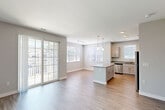 Located at 100 Flint Pond Cir, Unit 7131 in Shrewsbury, MA, this well-appointed 2-bedroom, 2-bathroom residence offers a thoughtfully designed single-floor layout. The open-concept living and dining area is bathed in natural light through multiple windows and sliding glass doors that lead to an outdoor balcony, creating a bright and airy atmosphere. Light-toned hardwood-style flooring flows throughout the main living areas, complementing the neutral gray walls and clean white trim.

The kitchen features granite countertops, gray shaker-style cabinetry, stainless steel appliances, a central island with pendant lighting, and a convenient breakfast bar — ideal for both cooking and casual dining.

Both bedrooms are generously sized and finished with plush wall-to-wall carpeting. The primary bedroom connects to a full bathroom featuring granite countertops, gray cabinetry, a large mirror, tile flooring, and a tub-shower combination with white subway-tile surround. The second bedroom includes a bright window and ample space. A double-door closet provides excellent storage. The second bathroom mirrors the same quality finishes found throughout the home, ensuring a cohesive, modern aesthetic across the entire unit.