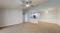 Located at 800 Gunn Rd in Centerville, Georgia, this single-floor home offers a well-designed, open-concept layout that balances comfort and functionality. The spacious living area features plush wall-to-wall carpeting, soft neutral-toned walls, and a ceiling fan, creating a bright and welcoming atmosphere. The space flows seamlessly into a peninsula-style kitchen, which is equipped with white cabinetry, granite countertops, stainless steel appliances including a refrigerator, range, microwave, and dishwasher, and durable wood-look flooring. Pendant lighting and a pass-through opening connect the kitchen to a defined dining area accented with wainscoting detail. The bedrooms are generously sized, each featuring plush carpeting, ceiling fans, and ample natural light from well-placed windows. The primary bedroom includes access to a walk-in closet. The bathrooms are finished with granite-top white vanities, wood-look flooring, and matte black fixtures that add a modern touch. One bathroom features a soaking tub with tiled surround. Throughout the home, clean white trim, consistent neutral paint, and thoughtful details contribute to a cohesive, move-in-ready aesthetic.