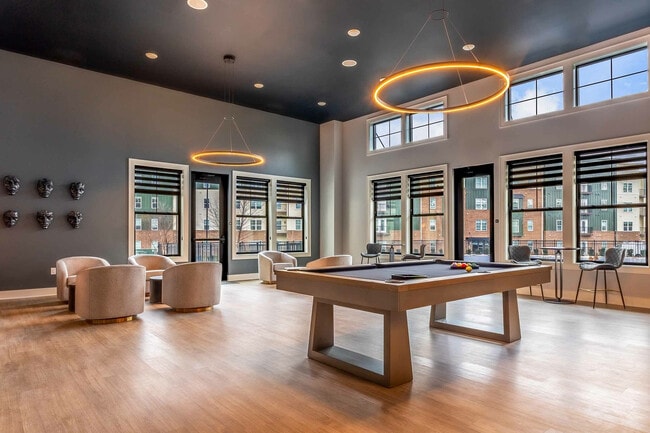 Experience modern elegance in this bright and inviting lounge space, perfect for relaxation and entertainment. - Colony Lofts