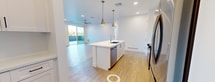 This contemporary 1,050 sq ft apartment in Avondale, AZ offers a harmonious blend of style and functionality. The heart of the home is an open-concept living area, featuring a gourmet kitchen with gleaming white cabinetry, stainless steel appliances, and a striking blue island that doubles as a breakfast bar. Pendant lighting adds a touch of elegance, while the subway tile backsplash enhances the modern aesthetic.

Two spacious bedrooms, including a 170 sq ft primary suite, provide comfortable retreats. The bathrooms boast clean lines with white vanities and tub/shower combinations. Light wood-look flooring flows throughout, creating a seamless transition between spaces.

Practicality meets convenience with an in-unit laundry room, complete with full-sized washer and dryer. The apartment also features a private balcony, offering outdoor space and views of the surrounding area.

Large windows in every room flood the space with natural light, while recessed lighting and ceiling fans ensure comfort. The neutral color palette and minimalist design create a canvas for personal style. With its thoughtful layout and high-end finishes, this apartment offers a premium living experience in a desirable location.