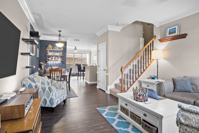 Photo - This inviting two-level townhome offers comfort and style, featuring gleaming hardwood floors on ...