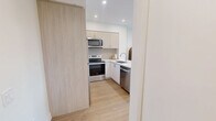 Located at 150 Wissler Rd in Waterloo, Ontario, this well-appointed one-bedroom, one-bathroom unit offers a thoughtfully designed layout with modern finishes throughout. The open-concept kitchen and living area forms the heart of the space, where light wood cabinetry, white quartz countertops, and stainless steel appliances — including a refrigerator, electric range, over-the-range microwave, and dishwasher — create a clean, contemporary kitchen. A peninsula with seating provides a casual dining option and separates the kitchen from the living area. Light hardwood-style flooring runs throughout, enhancing the bright, airy atmosphere. The living room benefits from a large sliding glass door that opens onto a private balcony, filling the space with natural light and offering pleasant outdoor views. The bedroom is a comfortable retreat with a large window, a built-in sliding door closet, and direct access to the bathroom. The bathroom features a full soaker tub with white subway tile surround, a vanity with storage, and clean, neutral finishes. A hallway connects the main areas efficiently, completing this well-organized and modern single-floor layout.