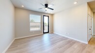 Located at 7319 Nordling Rd in Houston, TX, this well-appointed single-story home offers 2 bedrooms and 2 bathrooms with a thoughtfully designed layout. Light wood-style flooring flows consistently throughout the interior, complementing the neutral, warm-toned walls that create a clean and modern aesthetic.

The kitchen and living area share an open-concept design, with the kitchen showcasing white shaker-style cabinetry, light quartz countertops, stainless steel appliances including a refrigerator, range, and microwave, and a central island that provides additional workspace and casual seating. Recessed lighting adds a polished touch overhead.

The primary bedroom is generously sized, featuring a ceiling fan, access to a private outdoor balcony through a glass door, and a dedicated closet. The second bedroom benefits from multiple windows that invite abundant natural light and also includes a ceiling fan. Both bedrooms feature the same light wood-style flooring found throughout the home.

Both bathrooms are finished with marble-style tiled tub-and-shower surrounds, matte black fixtures and hardware, white vanities, and wood-look flooring, delivering a consistent, contemporary feel. A hallway connects the private areas of the home efficiently, and two closets provide ample storage. The overall ambiance is bright, clean, and move-in ready.