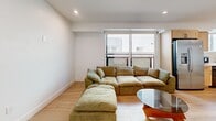Located at 1167 W 37th Pl in Los Angeles, this modern single-floor residence offers 3 bedrooms and 2 bathrooms with a clean, contemporary design throughout. Light wood-tone flooring runs seamlessly across the entire home, creating a cohesive and airy aesthetic. The open living area is anchored by a large window that welcomes natural light, while recessed lighting provides consistent illumination throughout. The kitchen is well-appointed with light maple shaker-style cabinetry, quartz countertops, a marble-look tile backsplash, a stainless steel gas range, and a stainless steel sink — combining both style and functionality. A dining area adjacent to the kitchen provides space for shared meals. Each of the three bedrooms is generously proportioned, featuring crisp white walls, recessed lighting, and ample closet space — including walk-in closets in select rooms. The primary bedroom is notably spacious. The two bathrooms maintain the home's modern character, showcasing floating vanities, vessel sinks, matte black fixtures, backlit mirrors, and wood-look tile flooring. A hallway connects the private and shared spaces efficiently. The overall ambiance is bright, minimalist, and move-in ready.