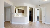Located at 888 E Clinton St in Phoenix, Arizona, this single-floor, three-bedroom, two-bathroom home offers a well-organized layout across a comfortable footprint. The open-concept living room is a welcoming centerpiece, featuring wood-look flooring, a ceiling fan with light fixture, a classic fireplace with a tiled surround, and large windows with vertical blinds that invite natural light. Sliding glass doors lead to a private outdoor patio, extending the living space seamlessly. The kitchen is thoughtfully designed with rich dark cabinetry, white countertops, a double stainless steel sink, and a pass-through breakfast bar that connects to the main living area. Black appliances, including a refrigerator, complete the functional space. Two hallways guide residents to three bedrooms, each carpeted and featuring ceiling fans and windows with vertical blinds for natural light and privacy. The spacious primary bedroom includes a dedicated closet with double hanging rods. Both bathrooms are finished with dark wood vanities, white countertops, wood-look flooring, and full tub-shower combinations. Clean neutral tones and consistent finishes throughout create a cohesive and comfortable atmosphere suited for everyday living.
