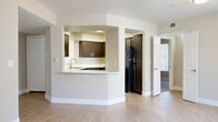 Located at 888 E Clinton St in Phoenix, Arizona, this single-floor, three-bedroom, two-bathroom home offers a well-organized layout across a comfortable footprint. The open-concept living room is a welcoming centerpiece, featuring wood-look flooring, a ceiling fan with light fixture, a classic fireplace with a tiled surround, and large windows with vertical blinds that invite natural light. Sliding glass doors lead to a private outdoor patio, extending the living space seamlessly. The kitchen is thoughtfully designed with rich dark cabinetry, white countertops, a double stainless steel sink, and a pass-through breakfast bar that connects to the main living area. Black appliances, including a refrigerator, complete the functional space. Two hallways guide residents to three bedrooms, each carpeted and featuring ceiling fans and windows with vertical blinds for natural light and privacy. The spacious primary bedroom includes a dedicated closet with double hanging rods. Both bathrooms are finished with dark wood vanities, white countertops, wood-look flooring, and full tub-shower combinations. Clean neutral tones and consistent finishes throughout create a cohesive and comfortable atmosphere suited for everyday living.