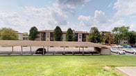 This single-floor residence is part of a well-established multi-story building complex set against a lush, tree-lined backdrop. The exterior of the complex is characterized by a neutral tan and brown color palette with structured vertical accents, giving the building a classic and understated appearance. The property benefits from a generous expanse of manicured lawn that adds an open, park-like quality to the surroundings, offering a pleasant outdoor environment for residents.

One of the standout practical features of this property is the dedicated covered carport parking area situated directly in front of the building. The carport provides multiple shaded parking spaces, offering residents protection from the elements year-round. The parking area is paved and clearly marked, ensuring ease of access and organized use.

Mature trees are scattered throughout the grounds, providing natural shade and contributing to the serene, residential atmosphere of the community. The overall setting conveys a quiet and established neighborhood feel. While interior images were not available, the well-kept exterior and thoughtfully designed communal spaces suggest a property that emphasizes comfortable, functional living within a community-oriented environment.